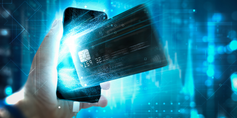 Hand holding smartphone with a credit card coming out of it on a technological background