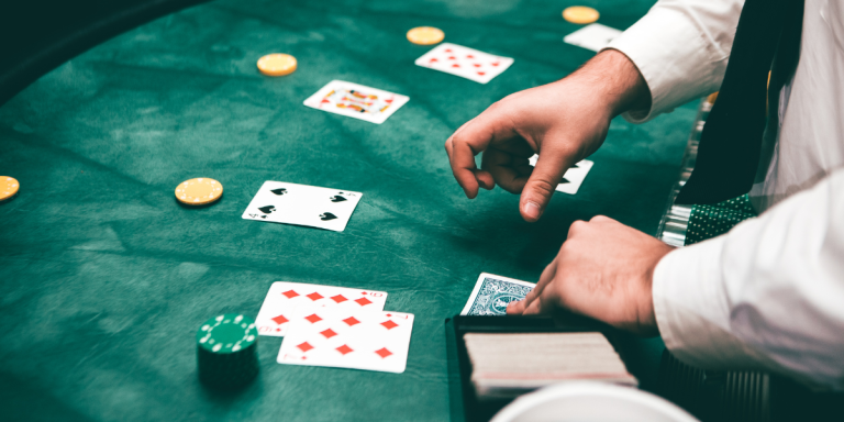 Dealer handing out poker cards on casino board
