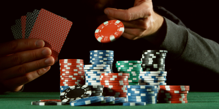 Image of man placing wager during poker game